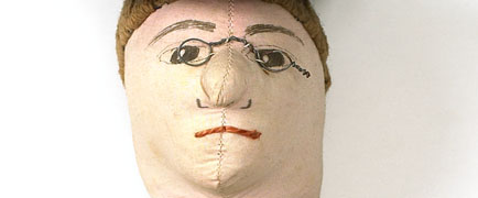 Detail from Votes for Women doll